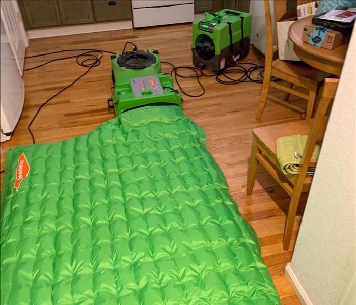 SERVPRO extracting water from the kitchen floor of a house
