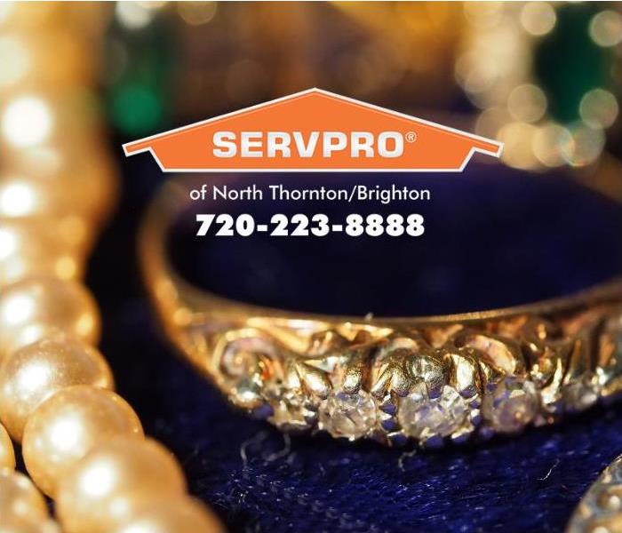 Family heirlooms - pearls and a rose cut diamond wedding band are displayed on a dark blue velvet surface.